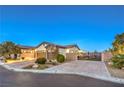 A single-story home with desert landscaping, three-car garage and gated driveway at 5640 Willow Canyon St, Las Vegas, NV 89149