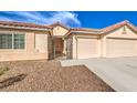 Welcoming facade of a single-story home with a gated courtyard and an attached two-car garage at 6217 Statue St, North Las Vegas, NV 89081