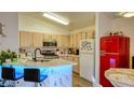 Bright kitchen with stainless steel appliances, marble counters, and a vintage-style refrigerator at 725 Wheat Ridge Ln # 201, Las Vegas, NV 89145