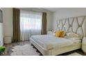 Elegant bedroom with large bed, soft lighting, and neutral tones at 725 Wheat Ridge Ln # 201, Las Vegas, NV 89145