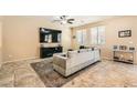 Comfortable living room featuring tile flooring, a ceiling fan, and lots of natural light at 7349 Merimack Oaks St, Las Vegas, NV 89166