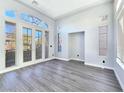 Open-concept living room with ample natural light, wood-look floors, and neutral color palette at 7695 Windy Meadow Ave, Las Vegas, NV 89178