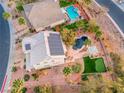 Aerial view of home featuring solar panels, pool, putting green, and covered patio at 784 Tossa De Mar Ave, Henderson, NV 89002