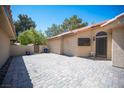 Beautiful tiled private front patio area with block fencing and front door at 7913 Sailboat Ln, Las Vegas, NV 89145