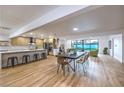 Open-concept living area with a dining space, modern kitchen, and access to the backyard pool at 8645 Edmond St, Las Vegas, NV 89139