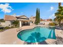 Inviting backyard pool and covered outdoor kitchen, perfect for entertaining at 10024 Skipper Ct, Las Vegas, NV 89117