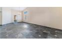 Open living room with chandelier and large window for natural light at 10024 Skipper Ct, Las Vegas, NV 89117