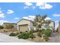 Single story home featuring desert landscaping, paver driveway, and 2 car garage at 10196 Millholm Ave, Las Vegas, NV 89166