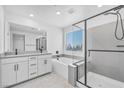 Luxurious primary bathroom with a double vanity, soaking tub, and glass-enclosed shower at 10214 Natural Anchor St, Las Vegas, NV 89166