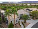 Stunning aerial view of the home showcasing the desert landscape and golf course views at 10261 Largo Sassetta Ct, Las Vegas, NV 89135
