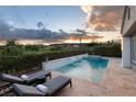 Inviting backyard pool with waterfall feature, lounge chairs, and lush landscaping for relaxing outdoors at 10261 Largo Sassetta Ct, Las Vegas, NV 89135