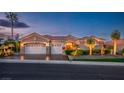 Attractive single-story home featuring a three-car garage, desert landscaping, and a well-maintained lawn at 10524 Longwood Dr, Las Vegas, NV 89134
