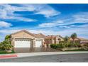 Lovely single-story home featuring a three-car garage, desert landscaping, and a well-maintained lawn at 10524 Longwood Dr, Las Vegas, NV 89134