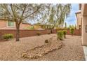 Landscaped backyard featuring desert landscaping and gravel ground cover for low maintenance at 10960 Prairie Grove Rd, Las Vegas, NV 89179