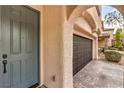 Close up front exterior of home shows front door and garage with a patterned brick paver driveway at 10960 Prairie Grove Rd, Las Vegas, NV 89179