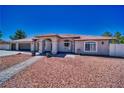 Charming single-story home featuring a desert landscape, covered entryway, and a spacious three-car garage at 1131 China St, Pahrump, NV 89048