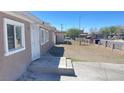 Inviting home exterior with clean lines, decorative door and an ample front yard space at 1308 Harriet St, Las Vegas, NV 89101