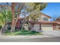 Inviting two-story home with mature trees, a well-kept lawn, and a convenient three-car garage at 1853 Heydon Ct, Henderson, NV 89014