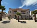 Two-story building featuring balconies and patios with desert landscaping and palm trees at 1964 Las Palmas Ln # 244, Laughlin, NV 89029
