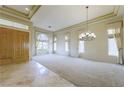 Bright living room with soaring tray ceilings, large windows, and an elegant chandelier at 2212 Sierra Heights Dr, Las Vegas, NV 89134