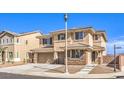 Two-story home with a two-car garage, steps up to the front door, and desert landscaping at 228 Via Vallisneri, Henderson, NV 89011
