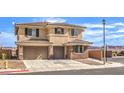 Two-story home with a three-car garage, desert landscaping, and a decorative tiled roof at 228 Via Vallisneri, Henderson, NV 89011