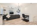 Spacious living area with hardwood floors, TV, and a designated desk area at 25 Barbara Ln # 38, Las Vegas, NV 89183