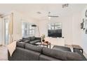 Modern living room with hardwood floors, a ceiling fan, and a comfortable gray sectional sofa at 25 Barbara Ln # 38, Las Vegas, NV 89183