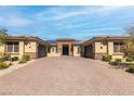 Charming single-story home featuring a symmetrical facade, stone accents, and a spacious brick driveway at 274 Chartan Ave, Las Vegas, NV 89183