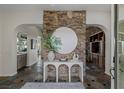 Elegant foyer with a stone accent wall, decorative console table, and slate tile flooring at 2822 Soft Horizon Way, Las Vegas, NV 89135