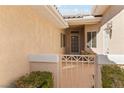Inviting front courtyard with white gate, tile flooring, and seating area at 3362 Pheasant Canyon Way # 1005, Laughlin, NV 89029
