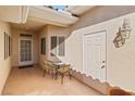 Inviting front courtyard with tile flooring, seating area, and white doors at 3362 Pheasant Canyon Way # 1005, Laughlin, NV 89029