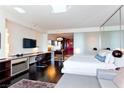 Stylish living space featuring a sleeping area, stainless steel kitchen, dark wood floors, and comfortable grey couch at 4381 W Flamingo Rd # 2605, Las Vegas, NV 89103