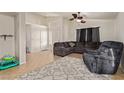 Spacious living room features neutral paint, ceiling fan, and tile flooring at 5019 Cactus Mesa Way, North Las Vegas, NV 89031