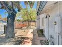 Home exterior showing front walkway with mature landscaping leading up to the entrance at 5049 Hibbetts Ct, Las Vegas, NV 89103