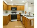 Traditional-style kitchen with wooden cabinets, a black range, and white countertops at 5130 Mandalay Springs Dr # 102, Las Vegas, NV 89120