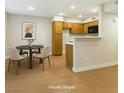 Open floor plan showcasing the kitchen and a dining area with modern decor at 5130 Mandalay Springs Dr # 102, Las Vegas, NV 89120