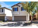 Charming two-story home features a neutral color palette, two-car garage, and manicured front yard with a mature shade tree at 5614 Bishop Flowers St, Las Vegas, NV 89130