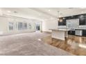 Spacious living area featuring hardwood floors and an open layout connecting to the kitchen at 5671 Camilla Cellars Ct, Las Vegas, NV 89141