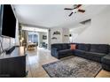 Inviting living room with tile flooring, a large sectional sofa, and an open layout at 6745 Jackson Junction St, Las Vegas, NV 89149