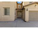 Front entrance with stone accents, covered porch and nearby two car garage at 6909 Forest Gate St, North Las Vegas, NV 89084