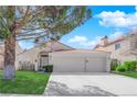 Charming single-story home features a red tile roof, attached two-car garage and a well-manicured front yard at 7405 Blue Sage Ct, Las Vegas, NV 89129