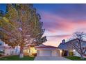 Charming home boasts a well-manicured lawn and a three-car garage at 7405 Blue Sage Ct, Las Vegas, NV 89129