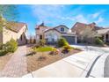 Beautiful one story home with manicured desert landscaping, charming exterior details, and a welcoming facade at 792 Valley Rise Dr, Henderson, NV 89052