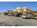 Exterior parking area with covered spaces in front of the condo building at 830 Carnegie St # 724, Henderson, NV 89052