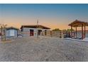 View of backyard buildings including a horse shelter, shed, and an awning at 9090 Josepine St, Pahrump, NV 89048