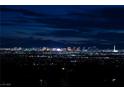 Expansive city view showcasing the bright lights of the strip at night and distant mountains at 979 Evening Dew Dr, Las Vegas, NV 89110