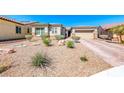 Inviting home boasting desert landscaping, a brick driveway, and a well-maintained exterior under a clear blue sky at 1012 Terron Allen Ave, North Las Vegas, NV 89031