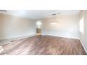 Open living space with rich wood flooring and contemporary light fixtures at 1088 Casady Hollow Ave, Henderson, NV 89012