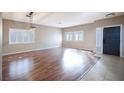 Bright living room with sleek wood flooring, modern lighting, and plantation shutters at 1088 Casady Hollow Ave, Henderson, NV 89012